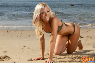 Ash-blonde hotty Amy models on a sandy beach in her swimsuit