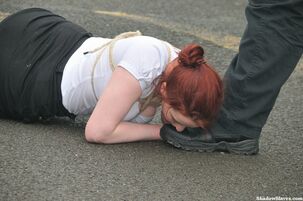 Ginger-haired munches her Master's footwear in parking