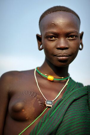 Nude tribe women, dark-hued african femmes without bra