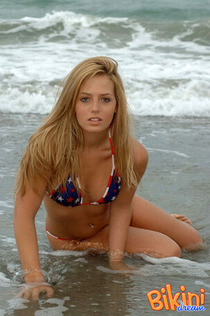 Ash-blonde nymph Shannon models in the surf wearing a