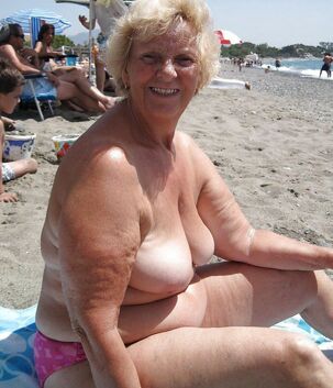 Bare Chubby grandma sunning on the beach