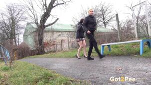 Antonia Sainz and Vanessa Hell cower to piss on a path while